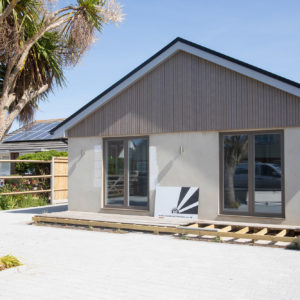 Larch cladding and smooth rendering to protect the property