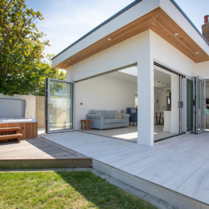 The middle bi-fold doors go into a clever pocket cavity in the wall to allow the interior wall to be used for a TV unit