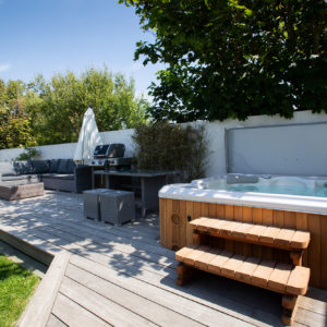The hot tub is clad beautiful in cedar helping it blend it into the garden colour palette