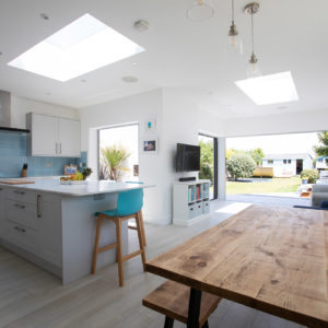 Two large clear glass roof lights add height and light to this open plan space