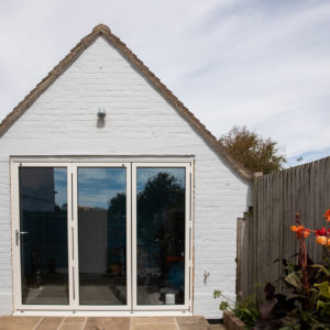 Bi-fold doors leading to the new home gym in the existing garage room