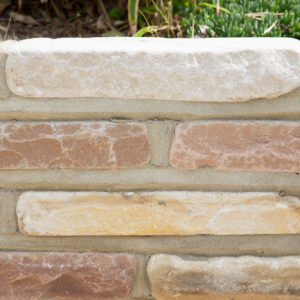 A closeup of the sand stone lower wall