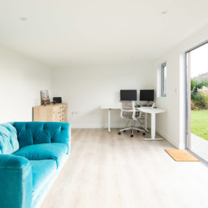 The roof of the garden room is angled upwards slightly toward the bifold doors