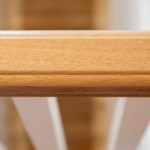 The oak hand rail on the banisters