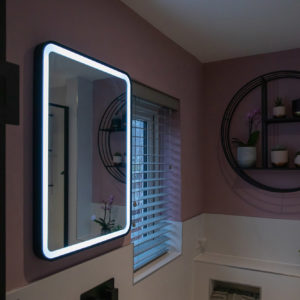 The LED lit mirror fits perfectly with the decorating scheme