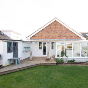 The rear view of the property showing the low conservatory roof and existing brickwork