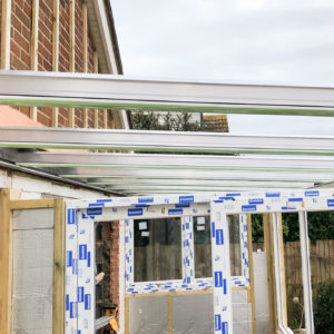 A metal roof system in installed to support the new heavy glass roof