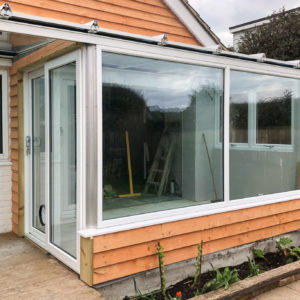 Large windows with no top vents allow a seamless view into the garden