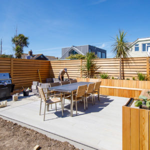 The planters are clad in vertical planks to contrast the horizontal strip fence