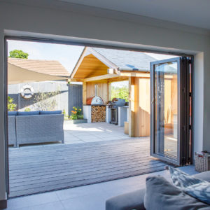 The bifolds from the house open out onto the decking for a flush seamless transition to the garden