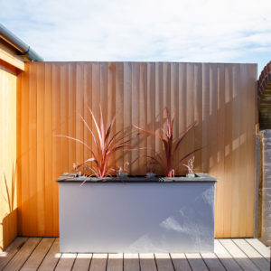 A custom planter topped with slate to compliment the outdoor kitchen worktop