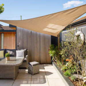 The shade sail also breaks up the architectural lines and shapes to give a third dimension to the garden