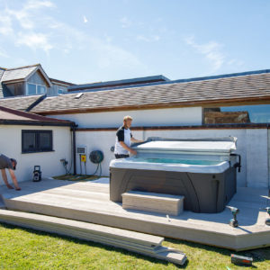 In the corner you can see the outdoor shower controls being installed - all pipework is hidden under the decking