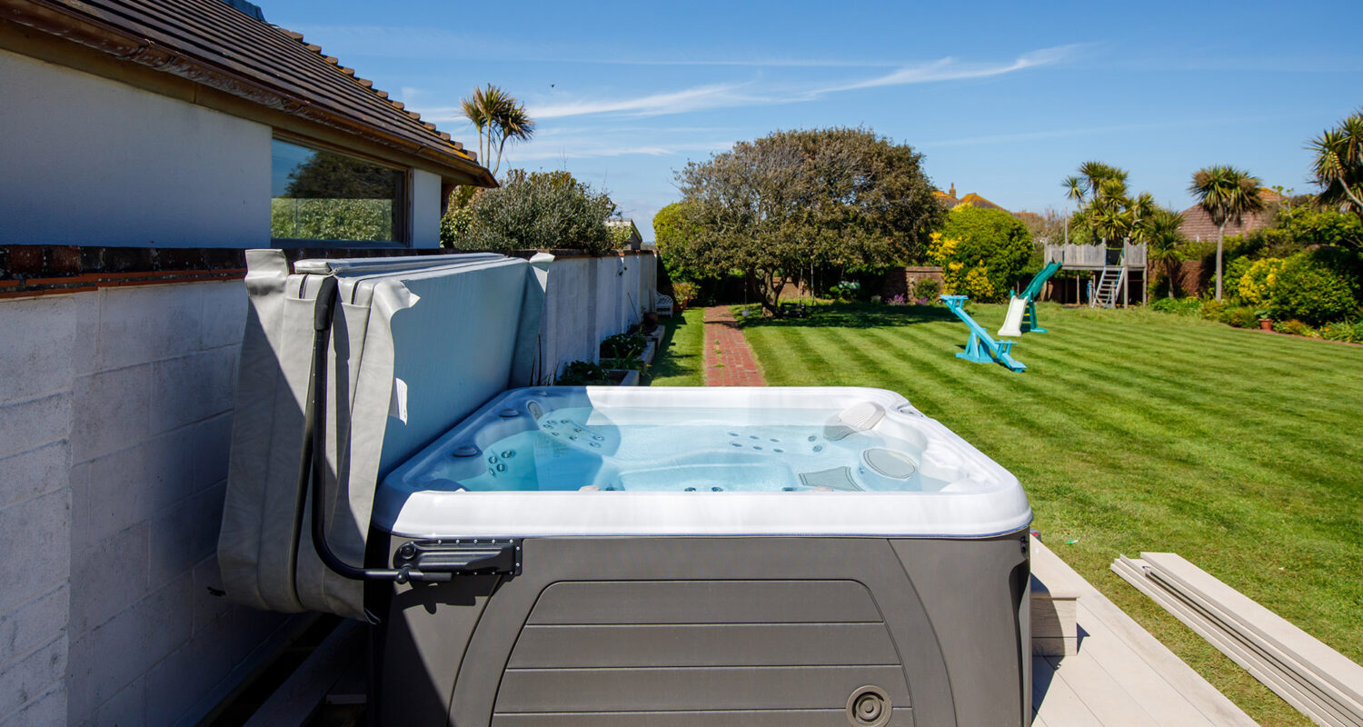 The hot tub is sunk down slightly into the decking with a small step to allow easy access