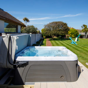 The hot tub is sunk down slightly into the decking with a small step to allow easy access