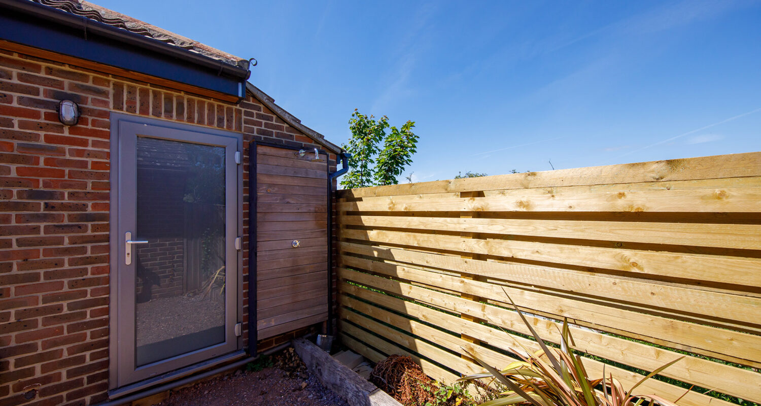 This is the new fence - the horizontal bars compliment the cladding throughout the project