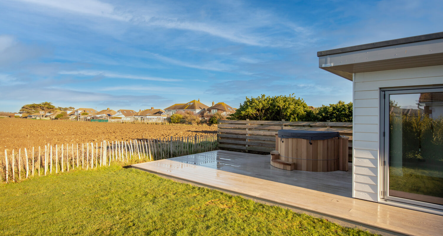 The composite decking wraps around the garden room