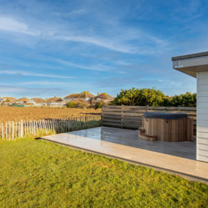 The composite decking wraps around the garden room