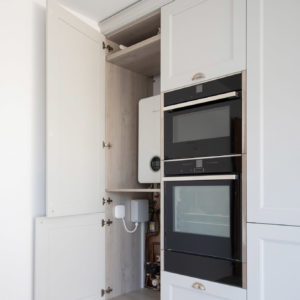 This large storage cupboard hides away the boiler and underfloor heating components well