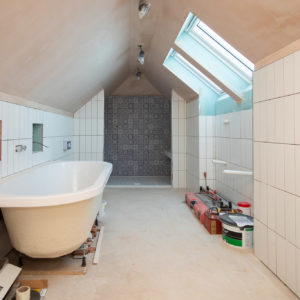 Upstairs clever use of the roof space for a bath room with walk in shower and double his & hers sink units