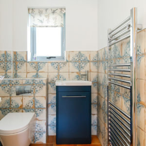 downstairs cloakroom with feature tiles
