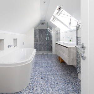 an impressive bathroom fits into the sloping ceilings