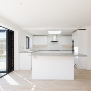 a kitchen island separates the kitchen to the living space