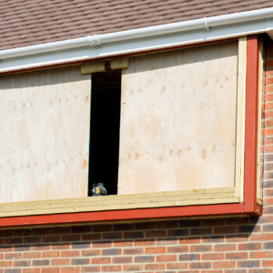 Part of the steel box protrudes outside and the other part sits inside the room.