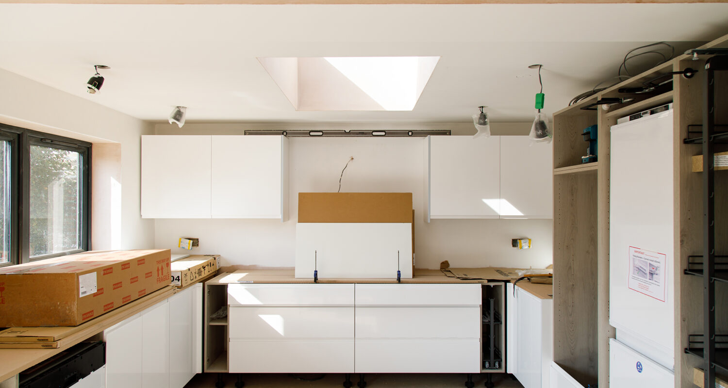 The large kitchen units are being installed, and you can already see how light is entering the room via the new roof light.