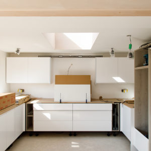 The large kitchen units are being installed, and you can already see how light is entering the room via the new roof light.