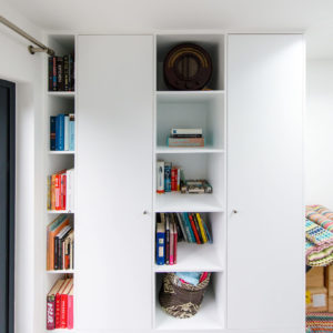 A bespoke storage unit built by our carpenter. This is made with traditional joinery skills with the shelves being crafted into the whole design. This gives a lux feel to the space.