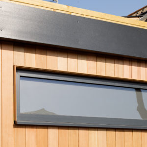 The new vertical cedar cladding looks great against the dark grey windows.