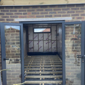 Freshly installed patio doors, showing new the lintel, and extended ceiling height.