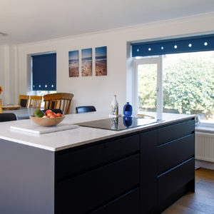 This large kitchen island houses a hob, storage and breakfast bar area.