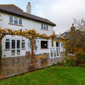 The side elevation showing the existing sized windows and doors before we knock through