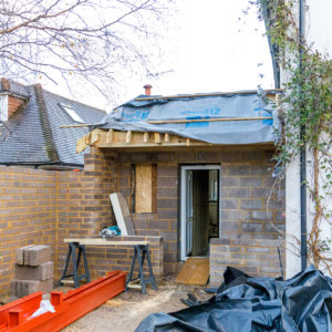 At the end of the new extension is a new porch, with a low wall and small windows into the boot-room behind