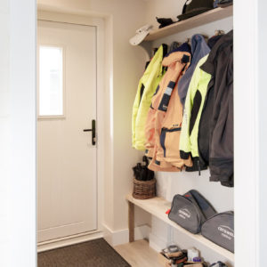 Simple wood shelves and a bench make this a very functional boot room