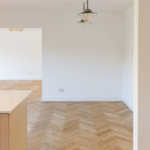 The solid oak herringbone floor runs through the entire downstairs