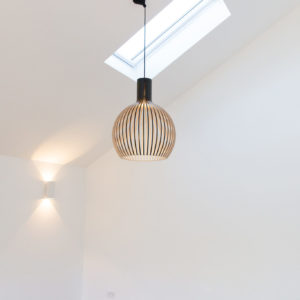 Light 'layering' is an important aspect of design: here we have wall lights, pendant lights, and roof windows.