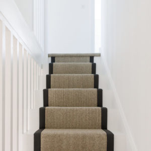 The stair runner has black edges to match in with the theme