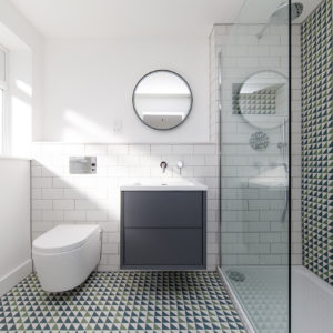 Shower storage cubby hole has tiles to match wall and floor.