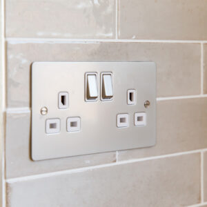 Flush sockets blend into the kitchen splashback tiles