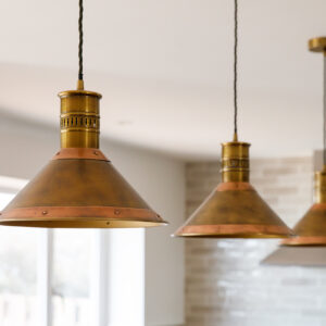 Antique style nautical lighting ties the design scheme together