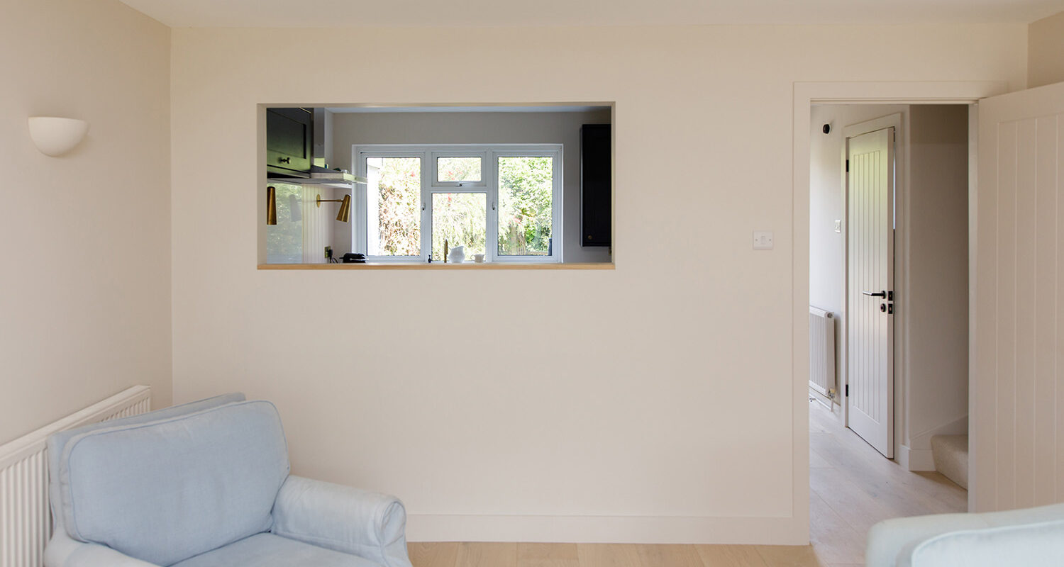 The open window through to the kitchen lets in light but also connects the two rooms