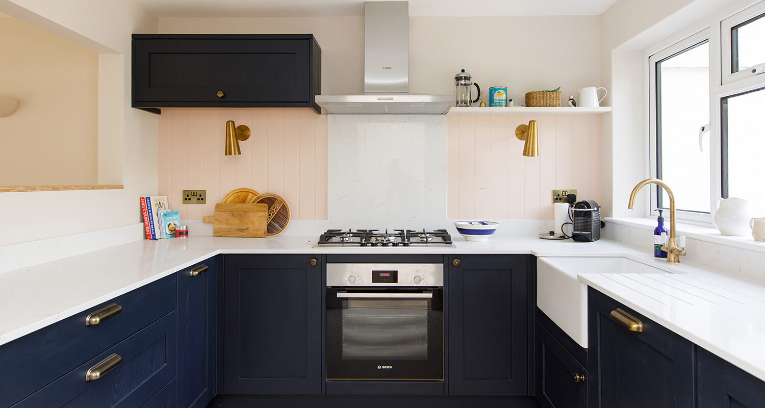 The dark navy kitchen is super modern, and is set off beautifully with a pale pink wall colour