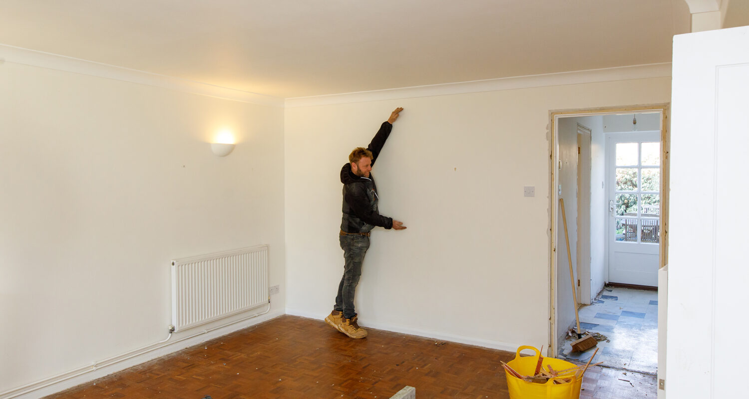 Here is Ian demonstrating the approximate height of the opening to the kitchen