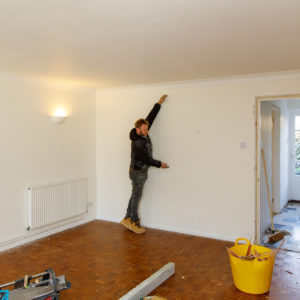 Here is Ian demonstrating the approximate height of the opening to the kitchen