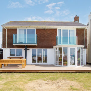 A large hardwood deck now spans the full width of the property