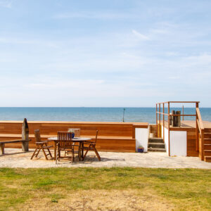 The original concrete retaining wall has now been clad in wood with a bench seat built into it