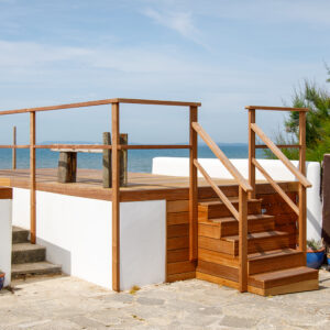 This raised platform was already here however we have re-done all the woodwork and decking, added new hand rails, and have built a large set of steps with storage underneath